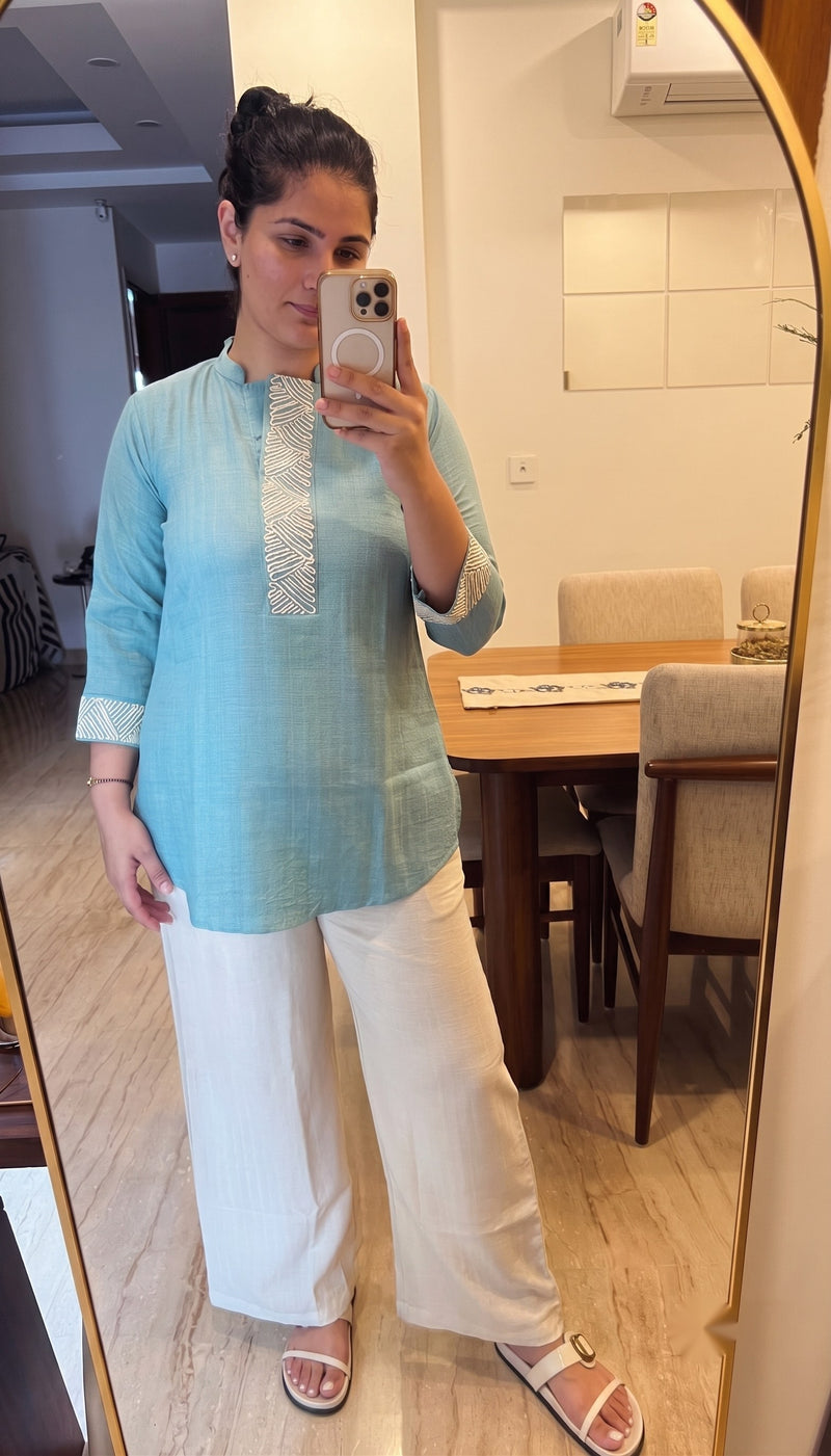 Customer wearing an aqua blue cotton kurta with white palazzo trousers