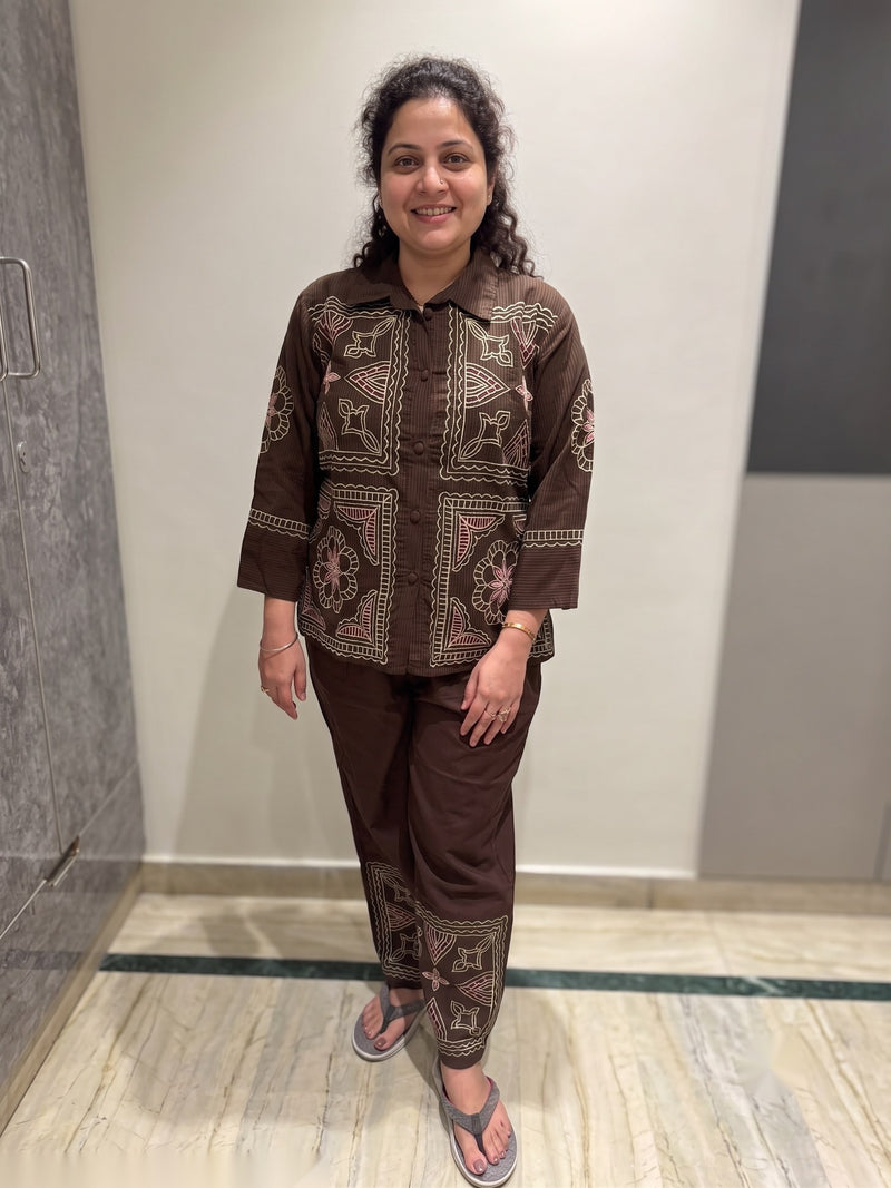 Customer wearing a brown embroidered cotton co-ord set with matching straight trousers